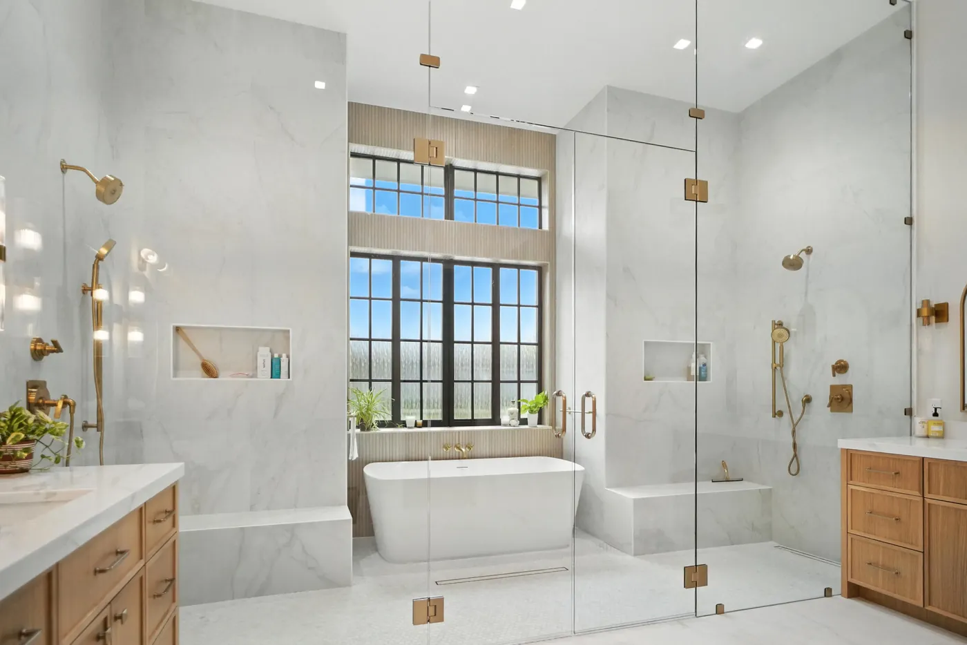 Primary bathroom with a soaking tub and glass shower in a Bluffton home by M&H Construction & Design