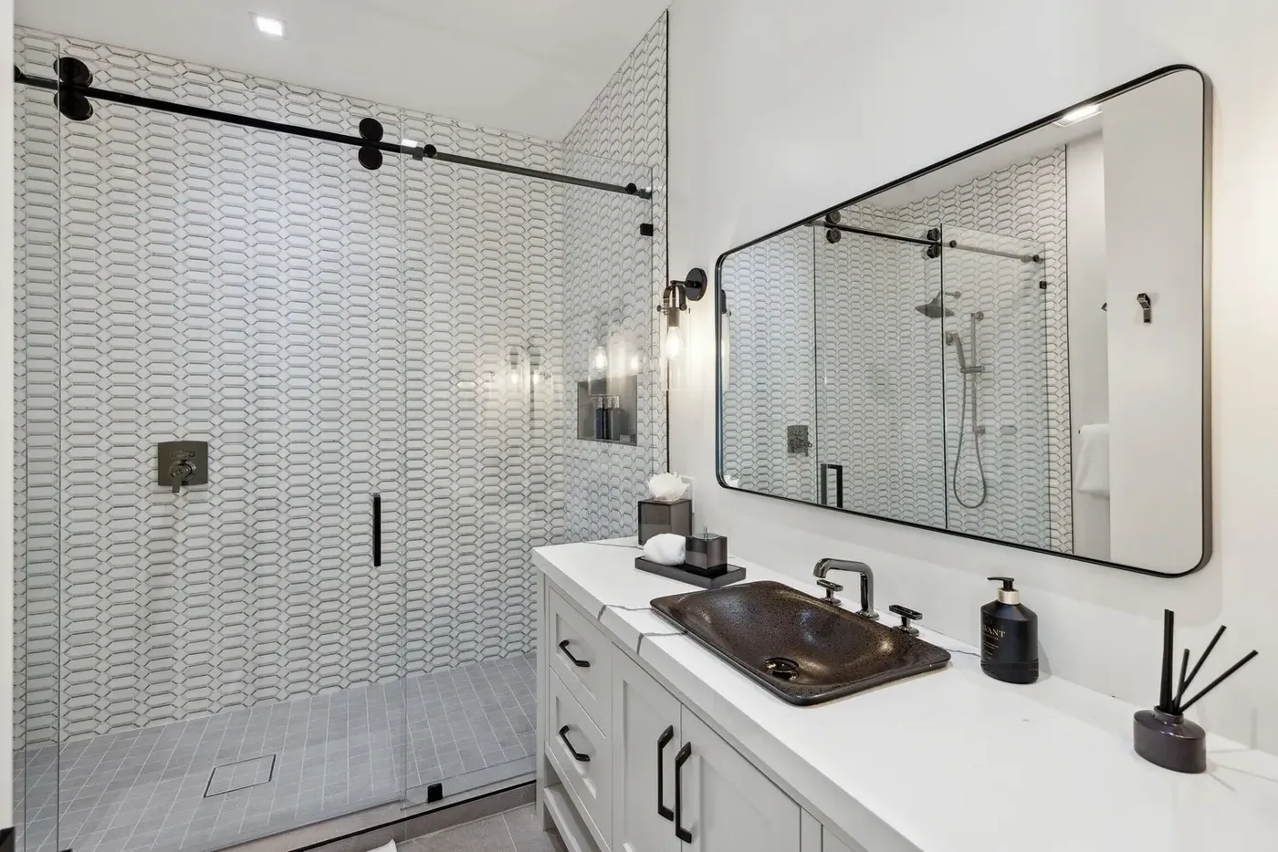 Timber & Tone completed en-suite in Bluffton with patterned tile, dark fixtures, and a glass shower