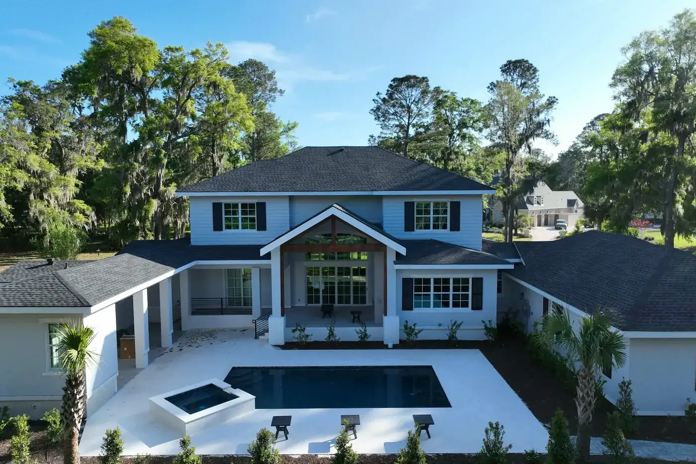 Aerial view of the completed Lumina Luxe residence with its pool and yard in Bluffton, SC