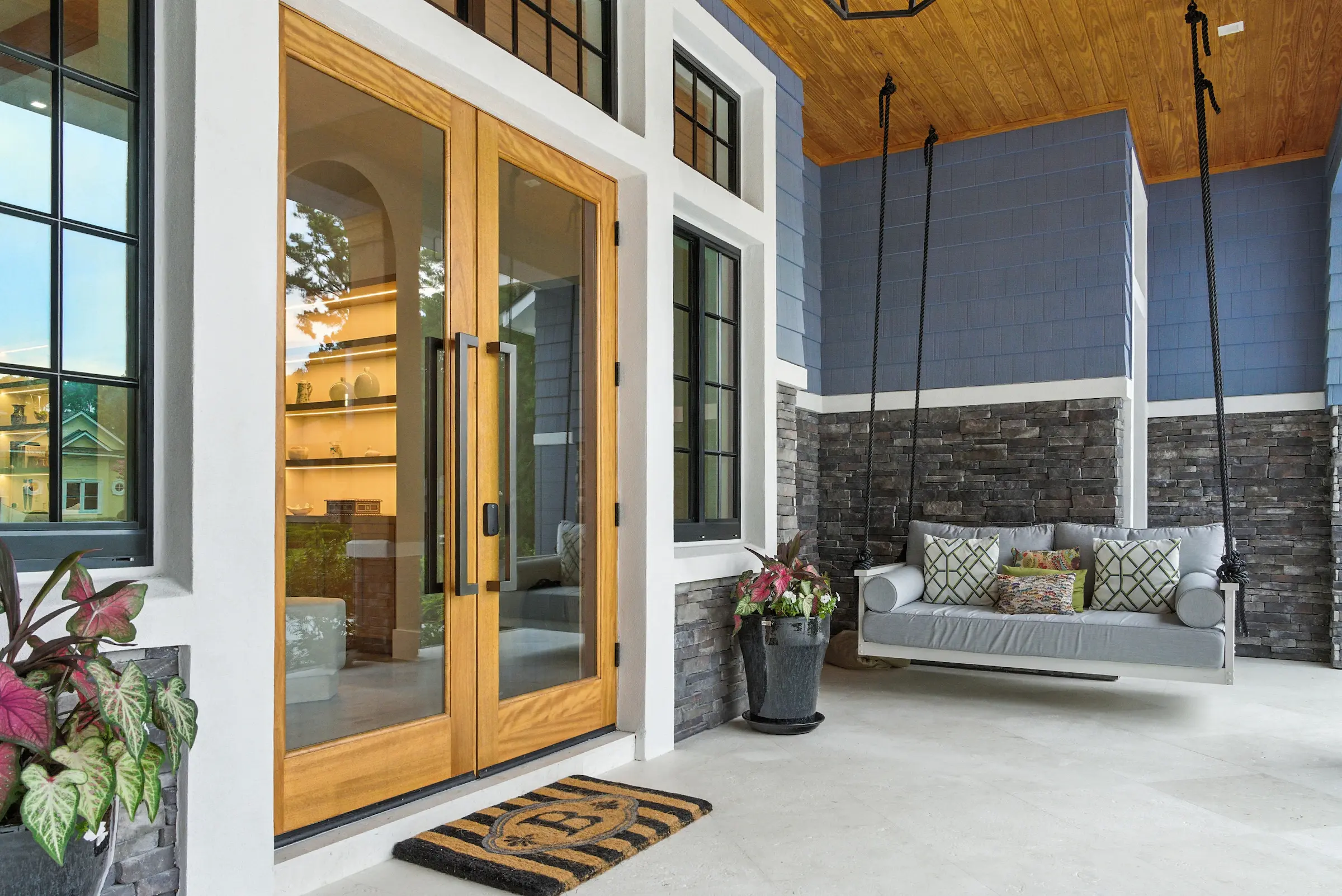 Coastal Craft screened porch with outdoor seating and wood ceiling
