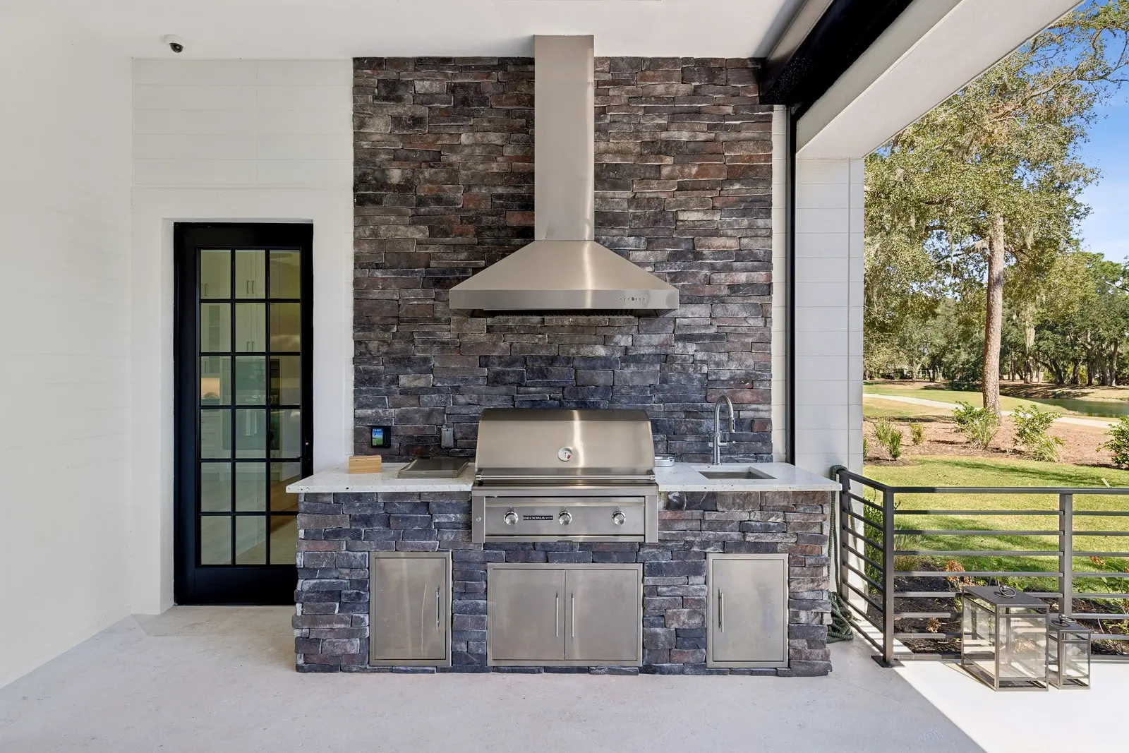 Timber & Tone covered porch with outdoor television and fireplace